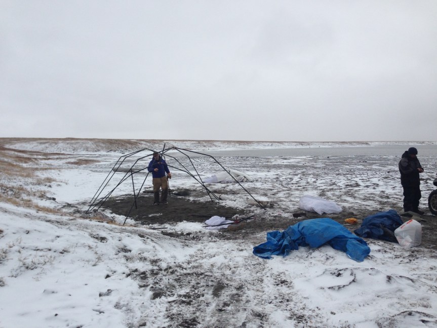 Tent & fly are packed and Jason Thomas is disassembling the frame.