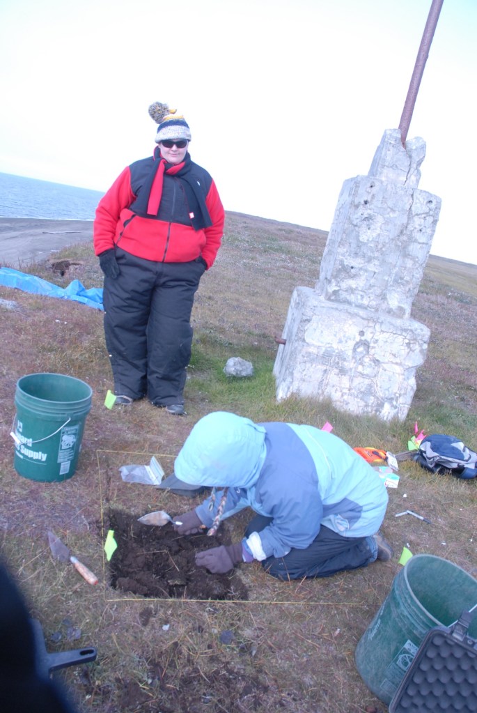 Laura Crawford excavating the SW quadrant of a 1x1 while Mary Beth Timm looks on.