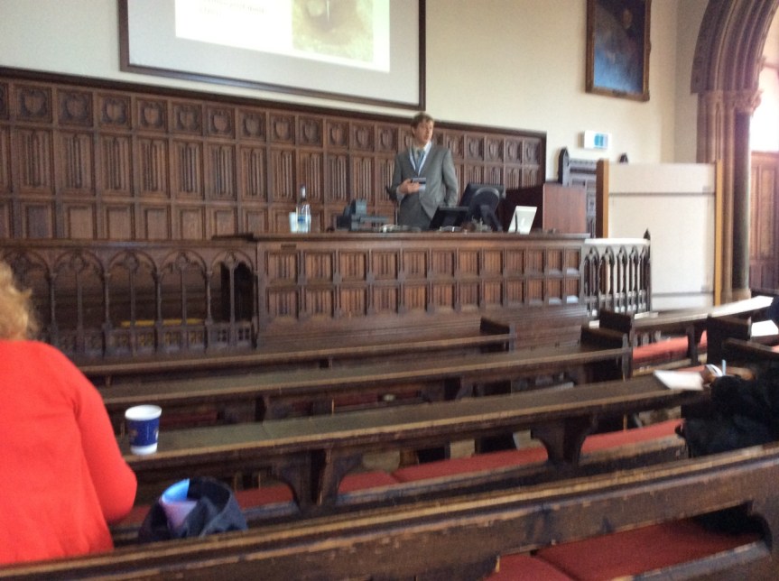 Nuvuk Archaeology Project alum Dr. Tony Krus chairing a session in a centuries-old lecture hall