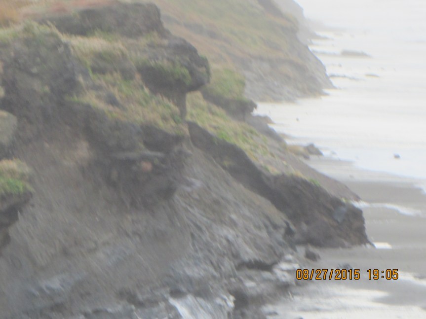 Waves eat at the Utqiaġvik bluffs.